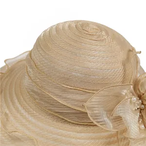 Detail of organza sun hat with layered mesh, 3D floral accent and pearl decorations