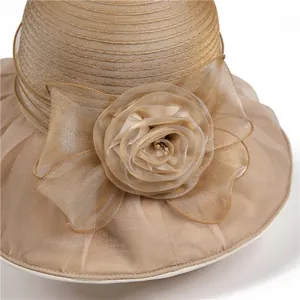 Women's sun hat with organza floral petals and pearl accents in champagne color