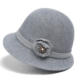 Detailansicht grauer Strick-Sonnenhut mit elegantem Blumenschmuck und Perlenverzierung