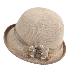 Elegant beige knit cloche hat with floral mesh and pearl beads for sun protection