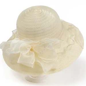 Detailed view of women's organza sun hat with large floral bow and pearl accents