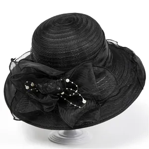 Detail of elegant black organza hat featuring mesh floral décor and pearl bead fringe