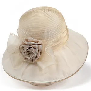 Detail of elegant champagne sun hat with spiral ribbon texture and organza flower