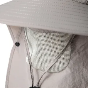 Detail of light gray sun hat featuring a white mesh breathable panel and facial cover