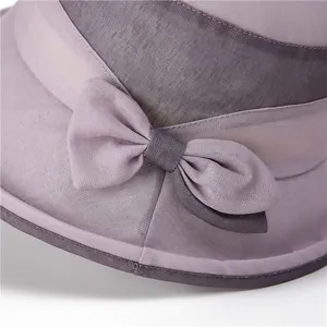 Elegant purple sun hat for elderly women with decorative bow and breathable fabric