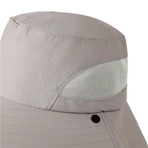 Close-up of waterproof hiking hat featuring breathable mesh vents and metal snap buttons