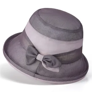 Detail of elegant grey sun hat featuring a sheer mesh fabric and decorative bow tie
