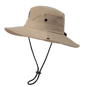 Detail view of khaki sun hat with breathable mesh, chin strap, and side snaps for hiking