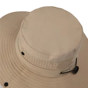Close-up of quick-dry khaki hiking hat showing mesh vents and adjustable wind cord
