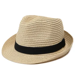 Close-up of the woven texture and black ribbon detail on this beige summer Panama hat