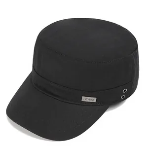 Detail of black cotton cadet hat featuring a silver metal logo and breathable vents