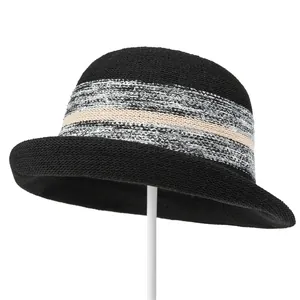 Detail of black knitted bucket hat with striped texture and elegant curved brim