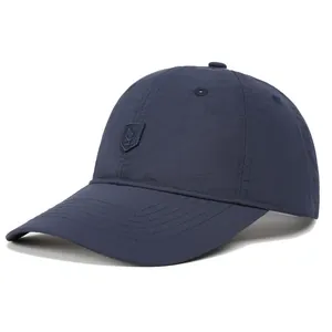 Detail shot of navy blue quick-dry fabric and shield embroidery on the baseball cap
