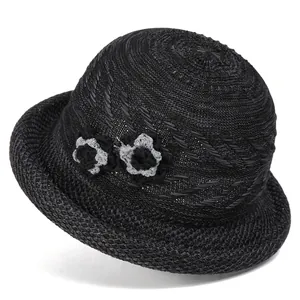 Close-up of black breathable woven sun hat featuring elegant side knit flower accents