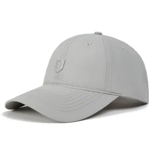 Close-up of light grey quick-dry baseball cap with silver shield logo and stitched brim