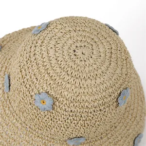 Women's wide brim straw sun hat with blue floral embroidery for beach vacations
