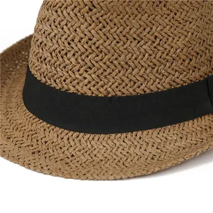 Detail of natural straw weave texture and black grosgrain ribbon on vintage jazz hat