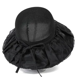 Detail of black sun hat with mesh crown, wide pleated brim, and subtle floral butterfly motifs