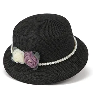 Detail of black straw fedora with white pearls and decorative fabric flower ornaments