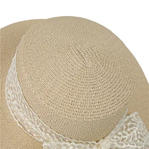 Straw sun hat with white lace ribbon detail and woven texture for summer vacation