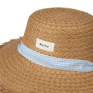 Blue gingham ribbon straw sun hat with frayed edge detail for summer beach vacations