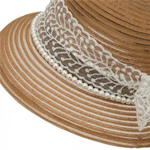 Detailed macro view of woven straw hat texture with white lace ribbon and faux pearl trim