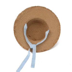 Women wide brim straw sun hat with blue gingham ribbon and frayed edges for beach