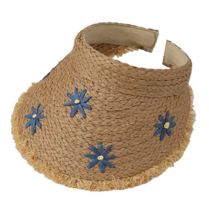 Straw sun visor hat with blue floral embroidery and fringe trim for beach vacation