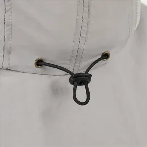 Detail of adjustable drawstring and metal eyelets on sun hat with neck protection