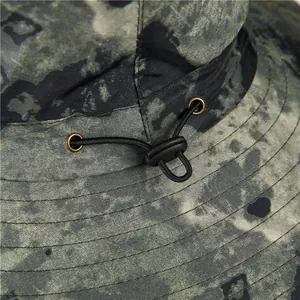 Detail of adjustable elastic drawstring and metal eyelet on camouflage sun hat