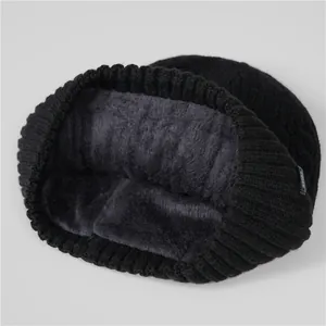 Close-up of thick grey faux fur lining and knit texture on a winter beanie hat