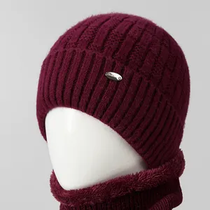 Close-up of wine red knit hat and scarf set with thick faux fur lining for warmth