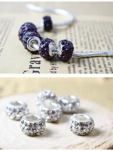 Macro detail of rhinestone-encrusted round charms for DIY jewelry on a silver chain