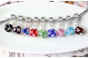 Macro shot of faceted zircon crystal charms in nine colors on silver plated chain