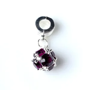 Detailed close-up of a deep purple faceted crystal charm with a silver metallic clasp