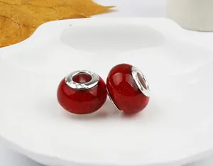 Macro shot of red glitter glass beads with S925 silver core for DIY bracelet making