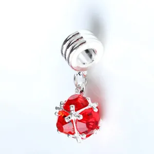 Macro detail of red zircon charm with snowflake metal frame for DIY jewelry