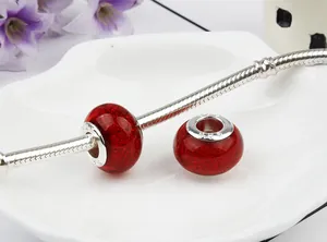 Macro detail of S925 sterling silver charms with red glitter crystals on snake chain