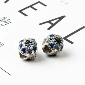 Macro detail of blue hollow-out charms with enamel and rhinestones for DIY bracelets