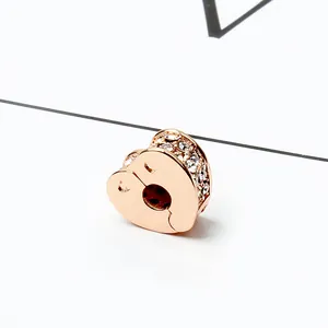 Macro shot of rose gold heart charm with pavé crystals for DIY jewelry bracelet