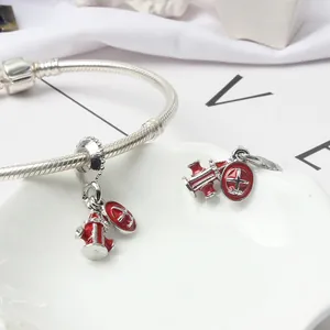 Silver snake chain bracelet with red enamel fire hydrant and medical cross charms