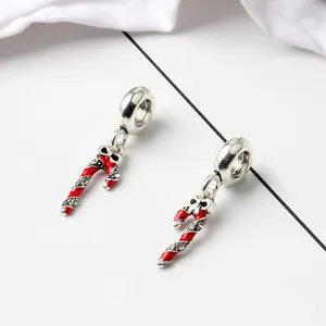 Macro detail of silver S925 candy cane charms with red enamel and pavé crystals