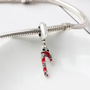 Macro detail of silver candy cane charm with red enamel and pavé zircons on snake chain