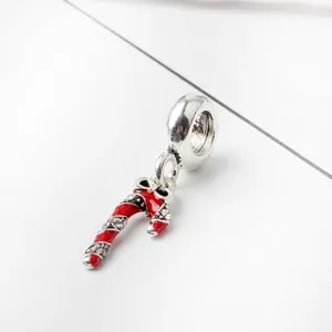Macro view of Christmas candy cane charm with red enamel and sparkling cubic zirconia