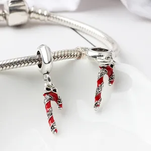 Macro detail of Christmas candy cane pendants with rhinestones on a silver snake chain