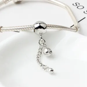 Detailed view of silver snake chain bracelet with polished bead pendant and mirror finish