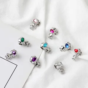 Detailed view of assorted colorful astronaut charms for DIY jewelry making and bracelets