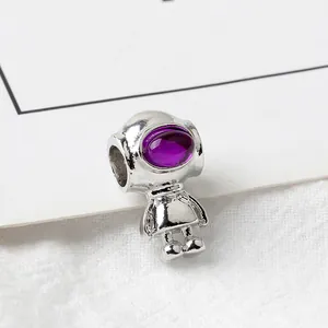 Macro view of silver robot bead charm with purple synthetic stone for DIY jewelry