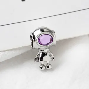 Macro shot of silver astronaut charm with purple gemstone for DIY beaded bracelets