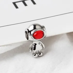 Macro detail of silver astronaut charm with red visor for DIY jewelry making
